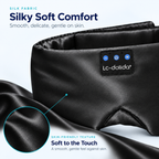 Close-up of the silk sleep mask fabric and audio controls