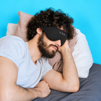 Man lying on his side wearing a black LC-dolida 3D sleep mask